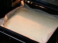 Pour the dough into baking tin lined with...