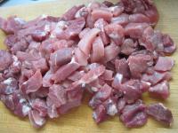 First, cut pork into thin slices and then into 3...