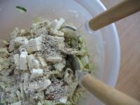 Cut salty cheese into cubes, add seeds and gently...