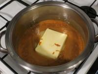 Add the butter to hot mixture and stir until it...