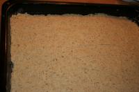 Spread the dough on a greased and floured baking...