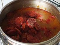 Remove the sausage from the cabbage soup, cut into...