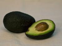 Cut avocado into halves, remove pit and use a...