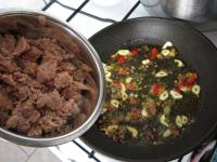 Cook garlic in oil for a while with crushed and...