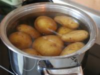 Boil the potatoes in their skins with a spoon of...
