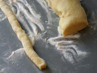 Make a right rolls from a dough on a floured...