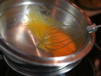 Melt the butter above the steam. Add egg yolks and...