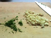 Cut marjoram and rosemary into small pieces with...
