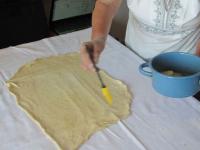 Start strechting the dough on table cloth....