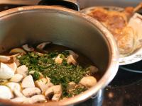 Remove the duck legs from a pot and separate meat...