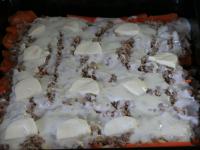 Place layer of meat mass over the layer of potato...
