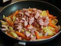 Add sliced sausages and fry for the last 10...