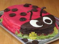 Replace red marzipan over the cake, with hand...