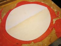 Roll out red marzipan on the board dusted with...
