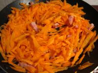 Add carrot into the bacon, pour in a water and...