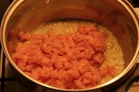 Add diced chicken meat and fry it. Let it stew in...