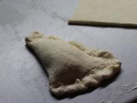 Use a rolling pin to spread the dough on floured...