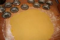 Use rolling pin to spread the dough until it is...