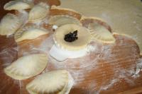 We roll out the dough on a mealted board circa 4...