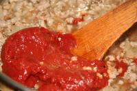 Add the tomato paste and basil. Stir and cook for...