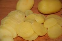 Peel the potatoes and cut them into thin slices....