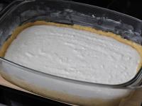 Pour the curd cheese cream on the dough. ...