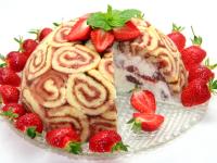 Decorate the cake with fresh strawberries and...