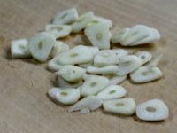Cut garlic cloves into slices....