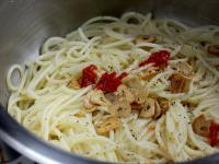 Put spaghetti back into dry pot and pour oil with...