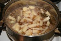 Then add salt, peeled potatoes cut into cubes, bay...