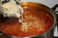 Once the meat is semi-soft, add sauerkraut, whole...