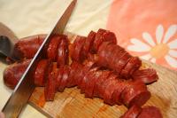 Once the sausage is cooked, take it out, cut into...