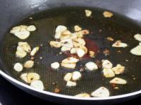 Slightly cook in oil slices of garlic together...
