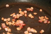 Cut smoked bacon into small cubes. Cook cubes of...