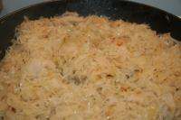 Add rinsed and squeezed sauerkraut into the onion...