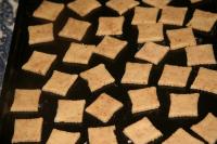 Place the cut out dough on baking tin and bake in...