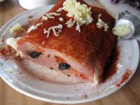 Press the plums into the holes. Season the meat...