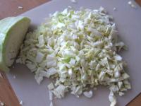 Cut the cabbage and with knife chop into the small...