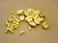 Peel the garlic, cut the cloves into the halves...