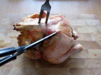 Remove the finished chicken from rack and cut it...