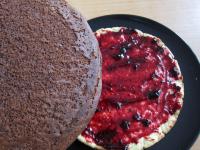Spread fruit jam over the first cake base and lay...