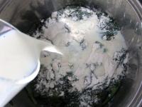 Dust steamed spinach with flour, add milk and half...