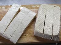 Cut the tofu in half, each half into thinner...