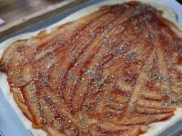 Brush the dough with ketchup and sprinkle with...