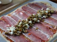 Lay thin slices of English bacon on the dough....