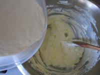 Add sugar and flour with baking powder and knead a...
