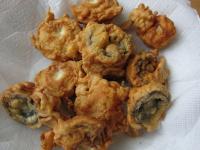 Remove the fried mushrooms with the holed laddle...