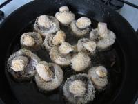 Place coated mushrooms into the hot oil......