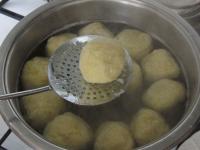 Remove the cooked kluski with a perforated ladle...