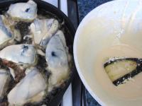 Heat oil in a pan, dip eggplants into the batter...
